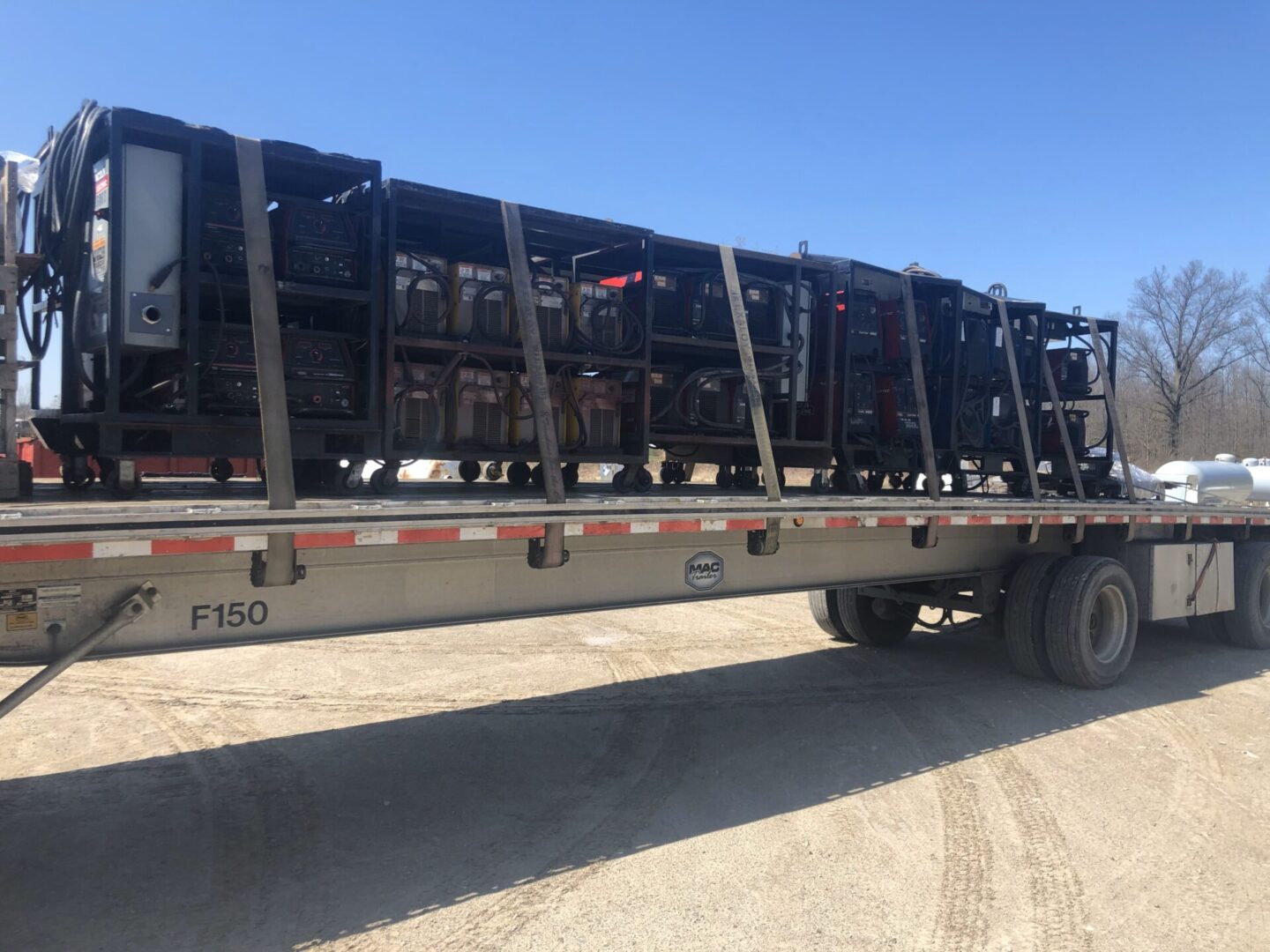 A truck with a trailer full of steel frames.