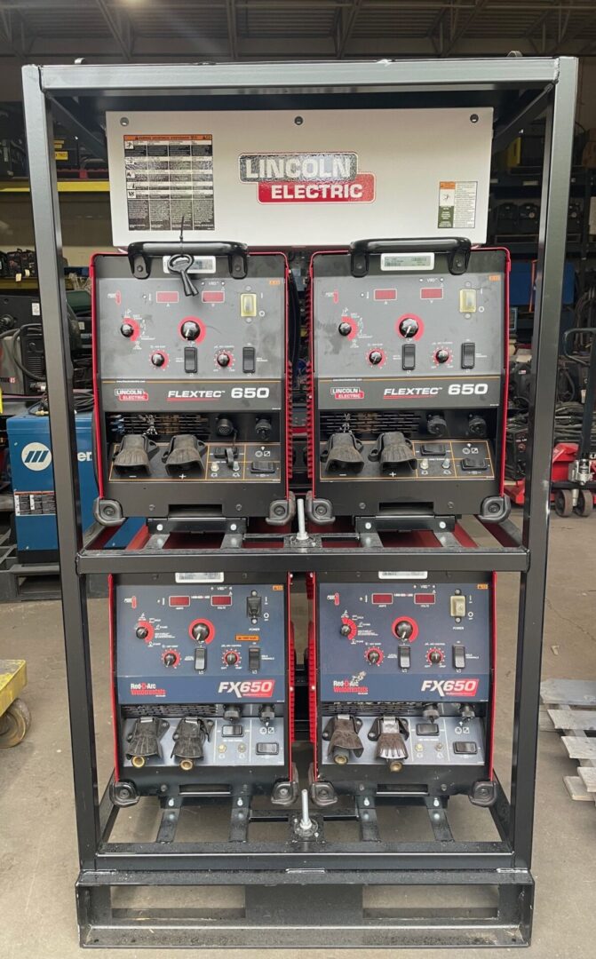 A rack of four electric welding machines.